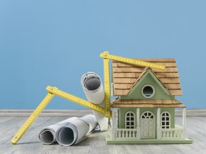 Model house, yardstick and blue prints on the floor. Do I need a Realtor for new construction?