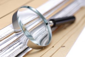 Magnifying glass Search Documents ; shot with very shallow depth of field ,